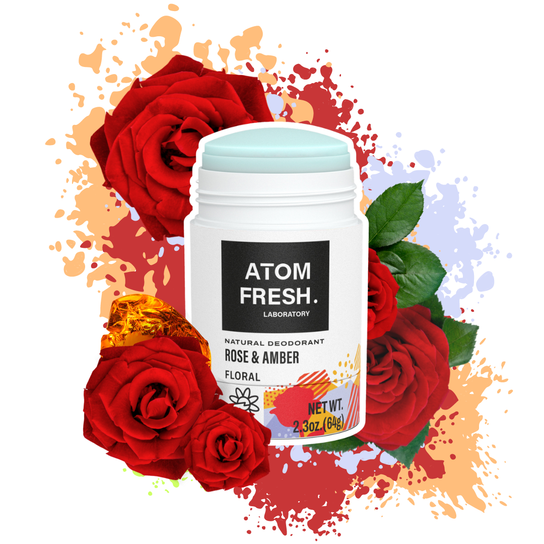 Atom Fresh Laboratory Rose and Amber natural deodorant surrounded by vibrant red roses, emphasizing the luxurious, floral scent and aluminum-free formula.